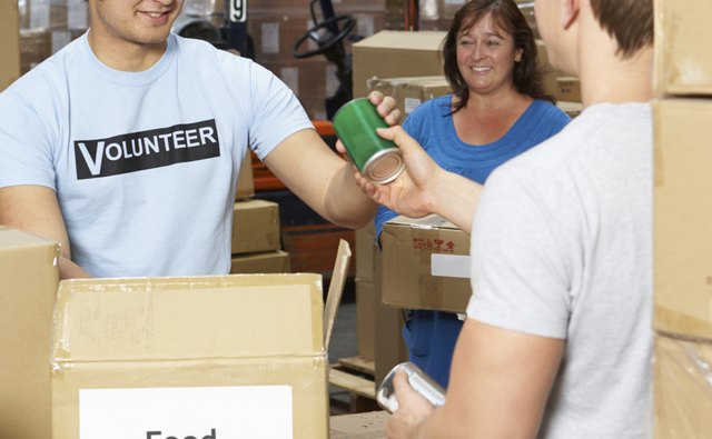 A volunteer collection food donations.