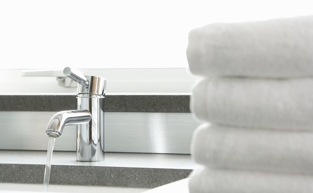 A stack of clean towels next to the sink.