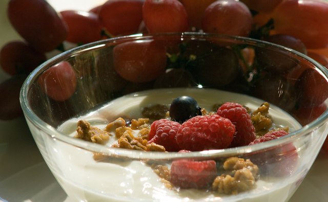 Mix yogurt with granola and berries for a delicious treat.