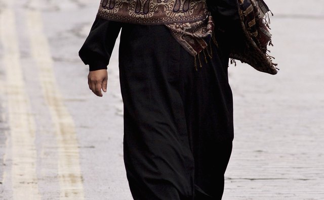 Some women wear a niqab, a black full-body cover that hides the face.