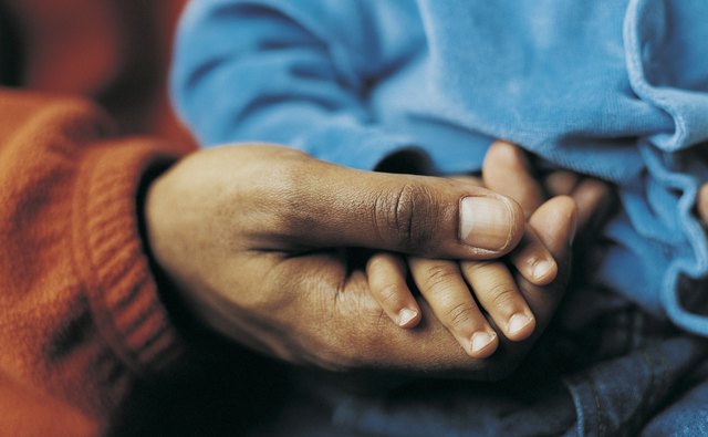 A toddler's hand provides a measure for his portion sizes.