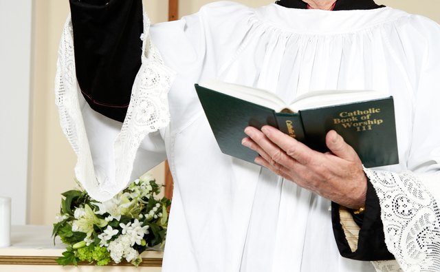 A priest follows the sacramentary from the Mass's opening prayers to its closing prayers.