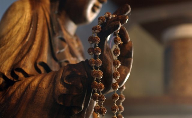 Followers may chant before a statue of a buddha.