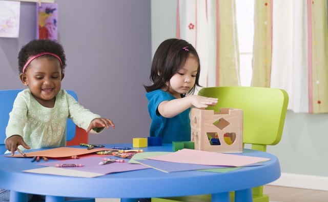 Toddlers engage in parallel play in which they play next to each other before learning to play together.
