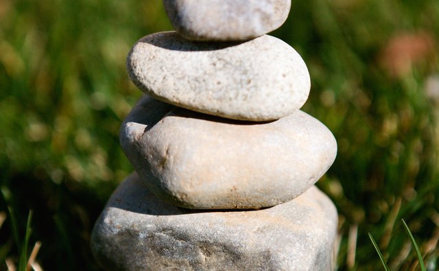 While flowers wither and die, stones represent permanence.