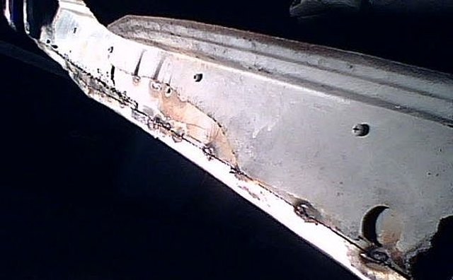 Lower rail or rear quarter panel.