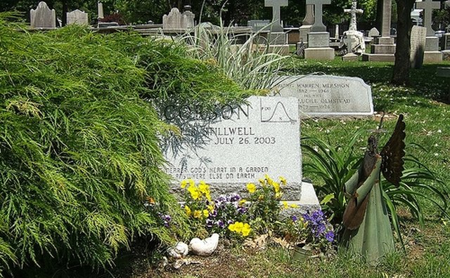 This mathematicians headstone features a bell curve in the upper right hand corner.