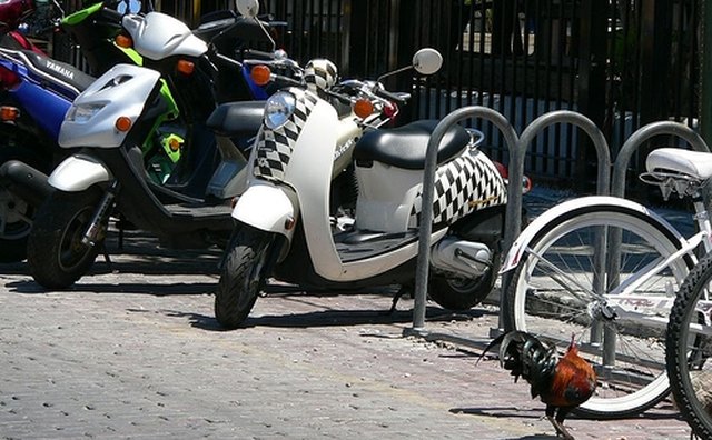 Scooter is readily identified by its step-through chassis and lack of pedals.