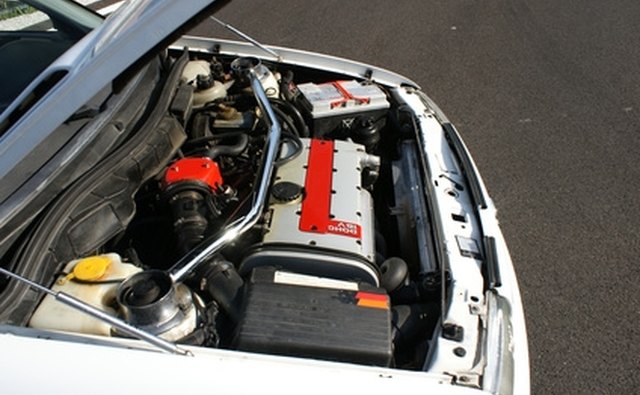 Diagonal gas spring at bottom left holds the hood up.