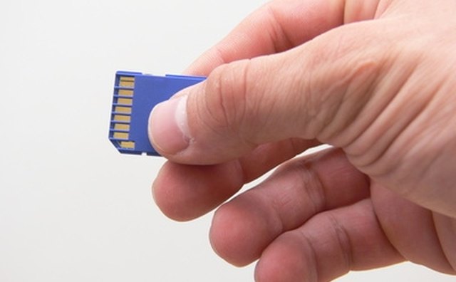 Several metal contacts are exposed on the back side of an SD card.