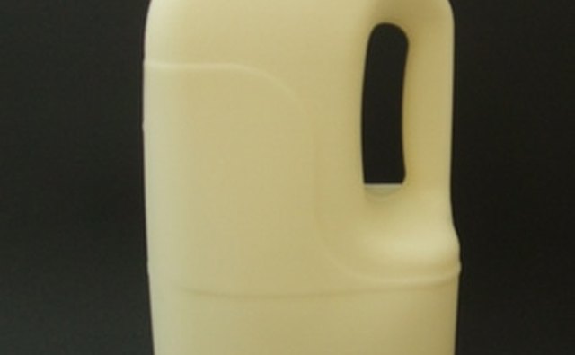 The cap of a milk jug conveniently holds roach bait in your car.