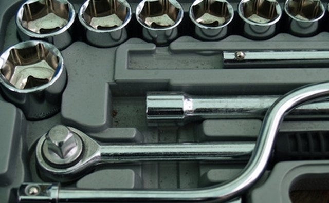 Use a socket and ratchet to remove nuts and bolts on pipes.