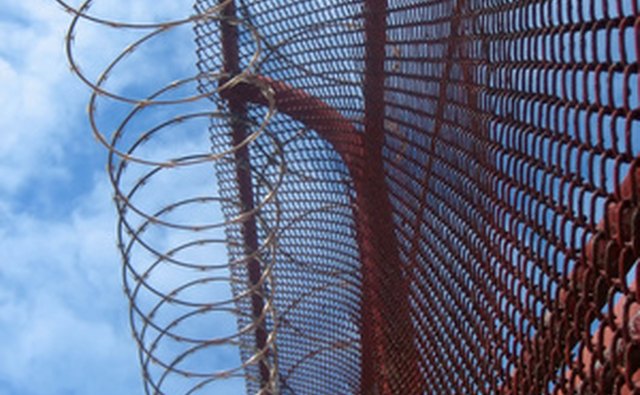 Prisons have barbed wire fences around their perimeters.