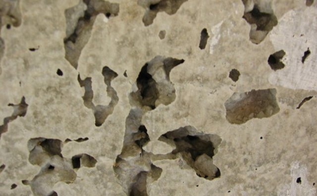 Concrete is porous and can be removed with certain chemicals.