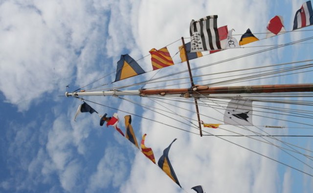 An array of signal flags dress the rigging of this ship.