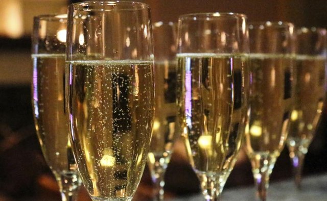 Champagne flutes lined up on a table.