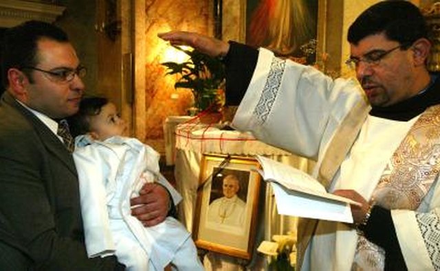 Young child being baptised inside cathedral