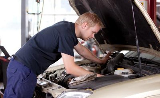 Mechanic fixing car engine
