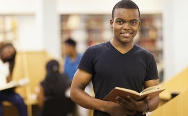 A student browses through a book at the library.
