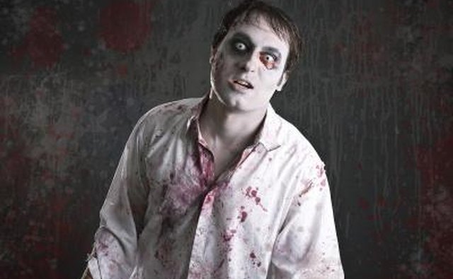 A man is dressed in a zombie costume.