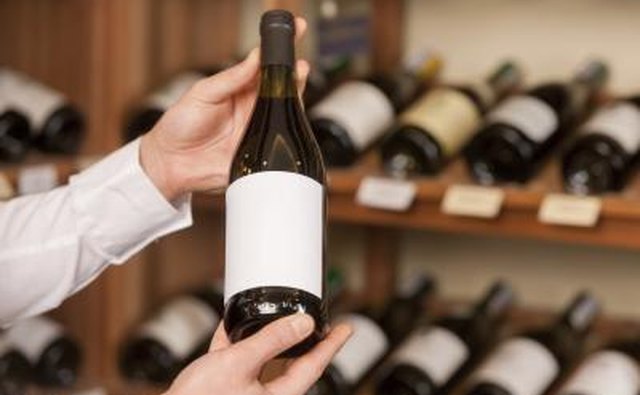 Man holding up nice bottle of wine in store