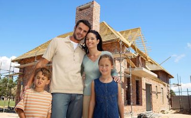 family infront of home being built