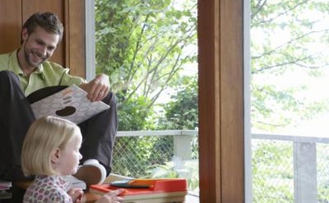 A dad smiling down at a vinyl record.