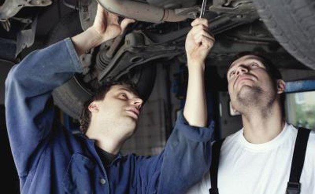 Mechanics looking at wheel bearings