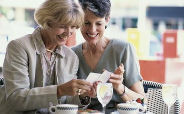 Two mature women looking at a photograph
