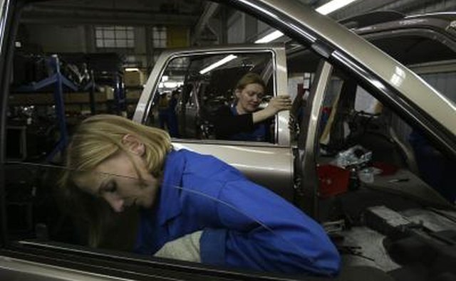 Workers assemble KIA automobile