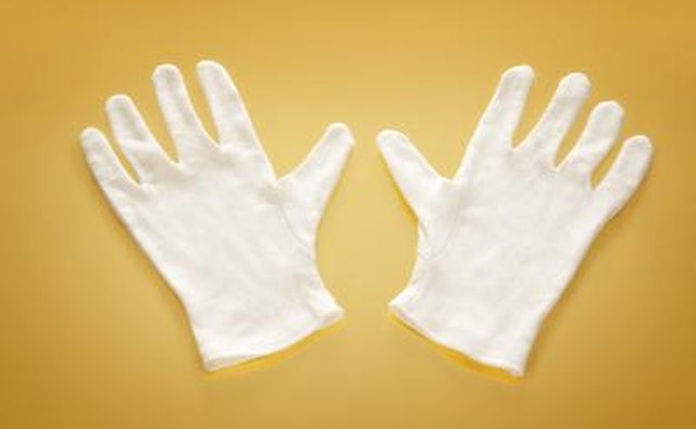 White gloves on yellow background.