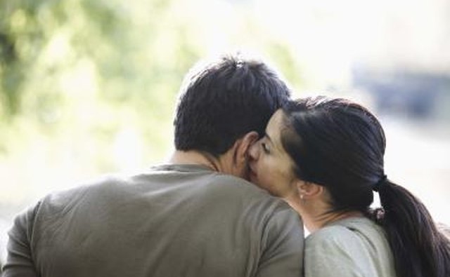 Woman whispering in man's ear