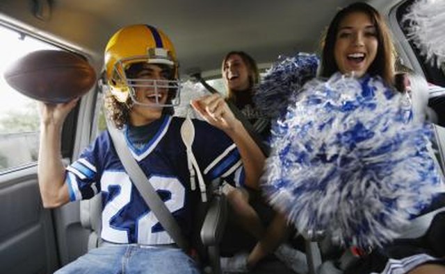 Teenagers driving to game in car