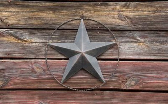 A close-up of an antique barn star on an old barn.