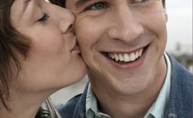 Woman kissing man on cheek