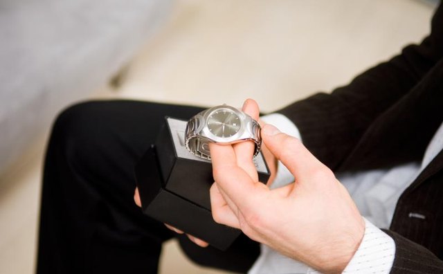 Man unwrapping a watch