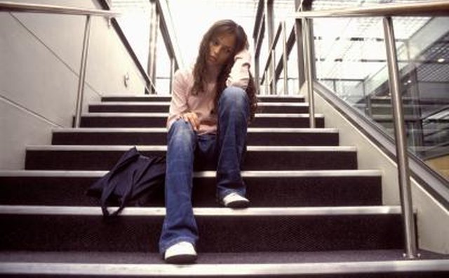 Girl sitting on stairs of high school