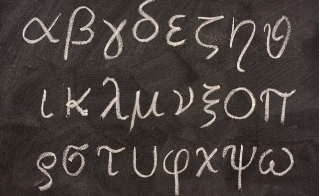 The letters of the Greek alphabet written on a black board.
