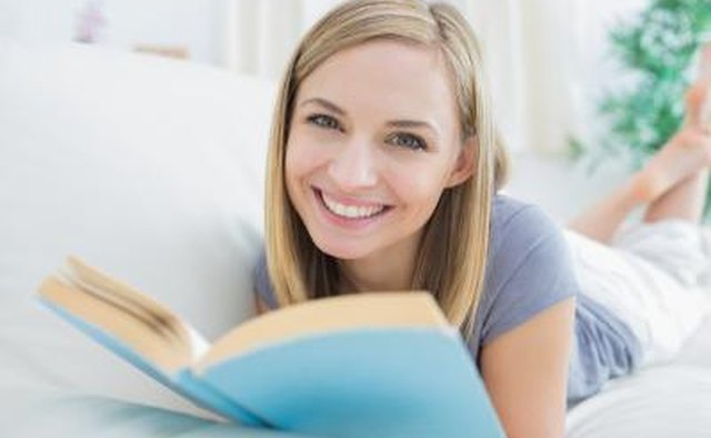 Woman reading book on sofa