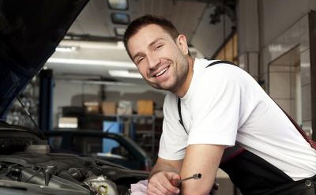 Use a hand wrench to loosen the retaining nuts holding the wire connections to the starter motor.