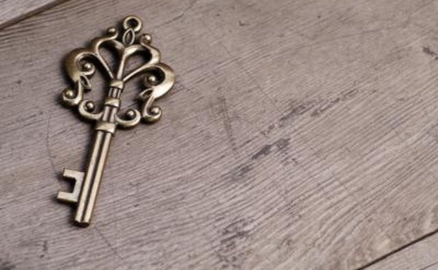 A gold skeleton key in the shape of a heart.