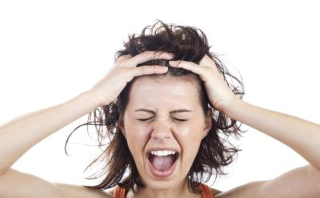 Woman grabbing her head in frustration.
