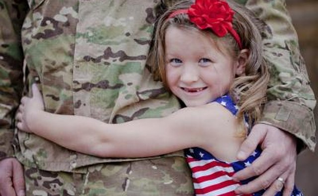 Little girl hugging soldier