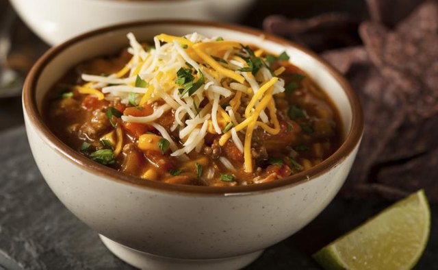 Bowl of chili topped with shredded cheese