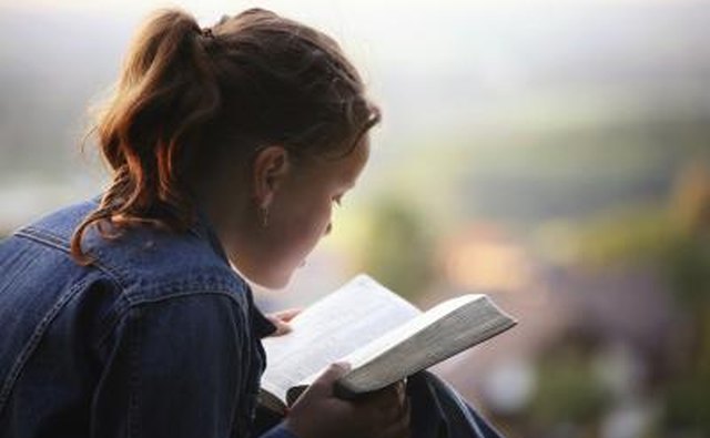 Young woman reading Bible.