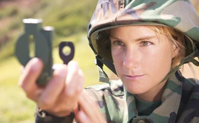 Soldier taking compass reading