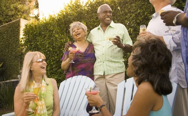 People laughing at a backyard gathering.