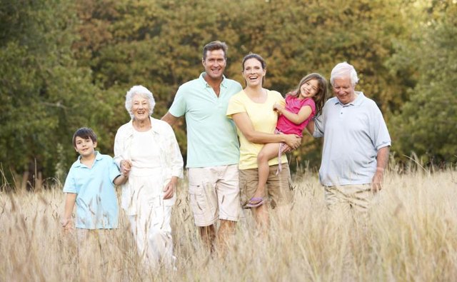 A family going on a walk through a field.