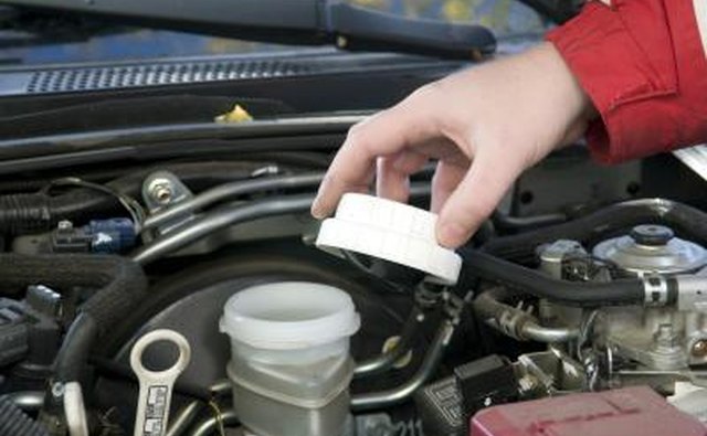man checking fluid levels in car