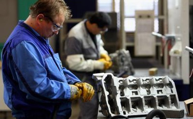 Men working on BMW engines